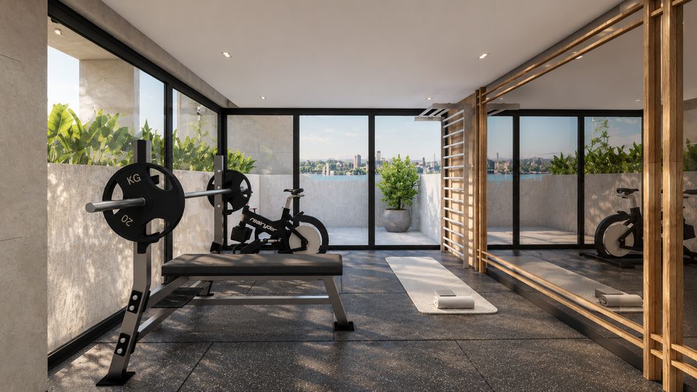 Gimnasio de la azotea con banco de pesas, bicicleta y vista al río Paraná