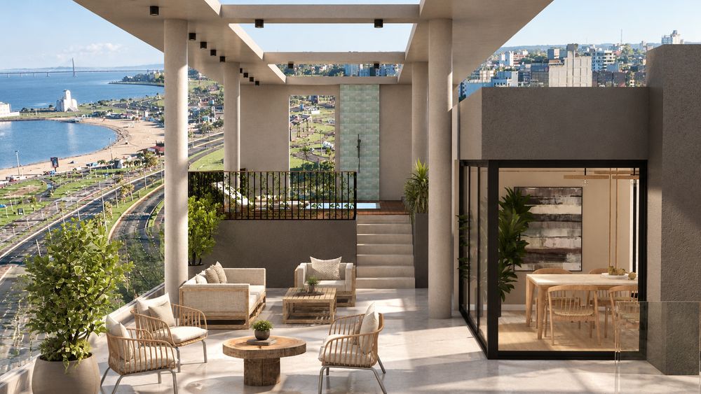 Terraza de la azotea con sillones, el quincho vidriado y vista a la costanera de Encarnación