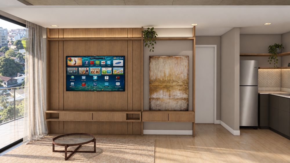 Estar del departamento modelo con mueble de madera y cocina integrada