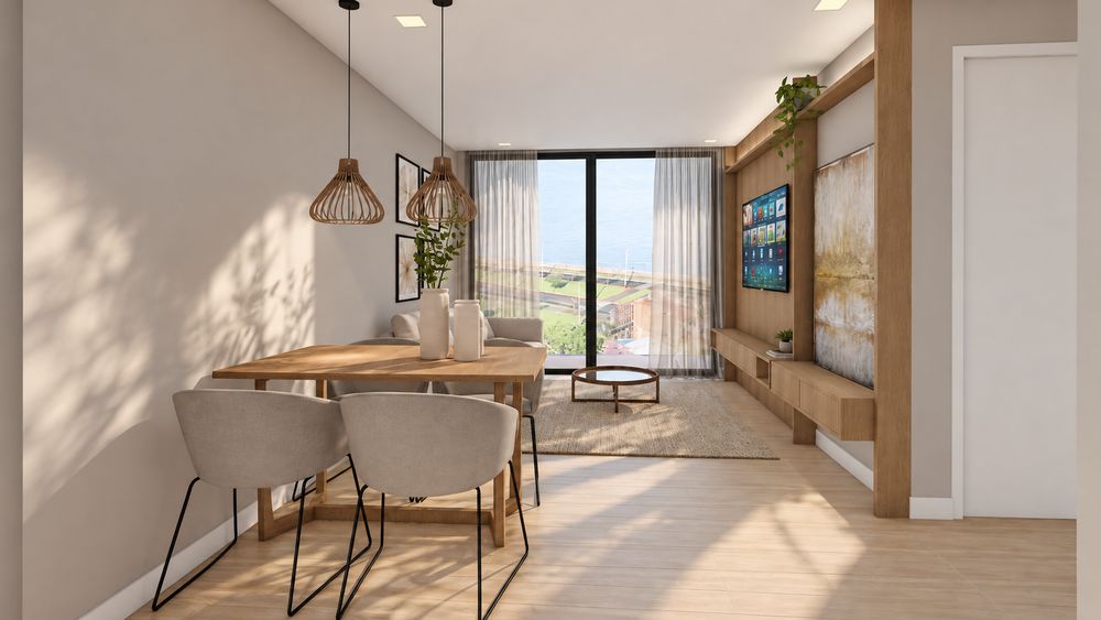 Comedor y estar del departamento modelo con vista a la costanera