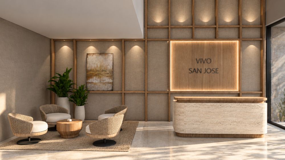 Lobby y recepción con pared revestida en madera y el logo de Vivo San José